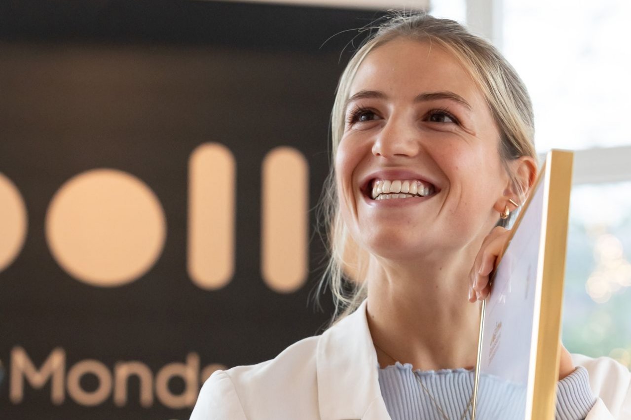 Lachende Juliana Döllerer mit Urkunde in der Hand